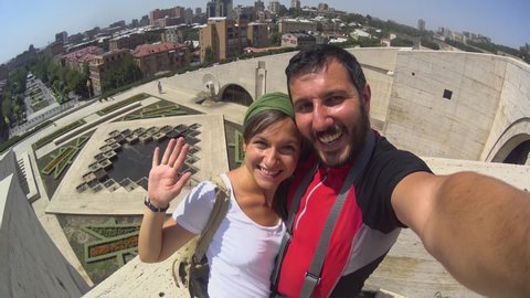 happy tourist couple in Armenia, taking selfie in Yerevan city on the steps of the Yerevan marble cascade