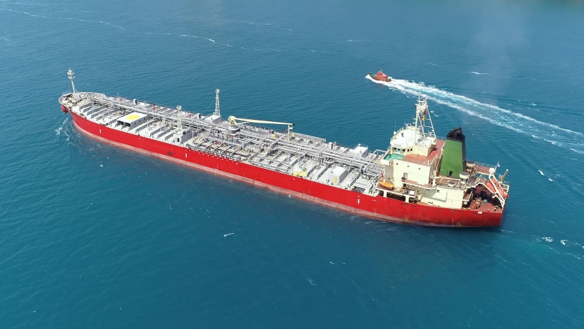 Supertanker loaded with full of oil underway in the open sea. Oil chemical tanker ploughs through the water. Aerial tracking video of a 182 meters long tanker ship
 Royalty-Free Stock Footage #1036923641