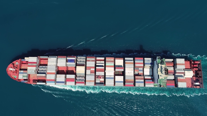 ISTANBUL - CIRCA 2019: Aerial top down. Container Ship SANTA CRUZ. Flying over the large cargo ship, full of containers sailing in Bosphorus Sea. Her engine roaring at full speed, leaving wake water
 | Shutterstock HD Video #1036923668