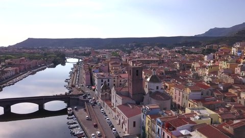 Bosa, Sardinia - Drone aerial shot at sunset over the colourful town of Bosa and the stone bridge on the river temo in Sardinia