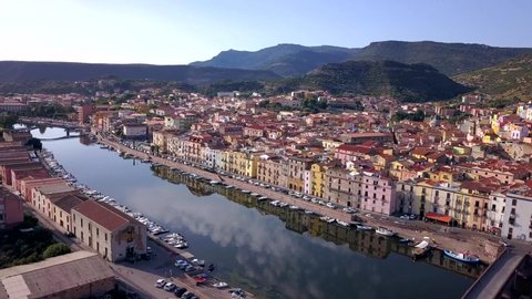 Bosa, Sardinia, Italy -Drone Arerial Shot discovering the colourful town of Bosa with a wonderful reflection on the river Temo. A typical Italian and mediterranean landscape