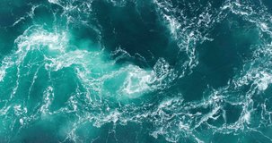 4K drone video with birds-eye view of the abstract and powerful water currents, rapids and whirlpools of the worlds larges maelstrom Saltstraumen in Bodø, Norway.
