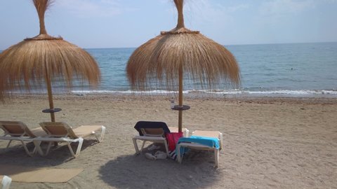 gimbal shot POV walking towards water on summer beach in marbella, malaga, spain, costa del sol popular vacation spot