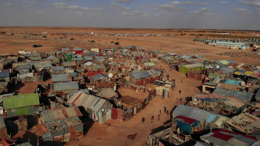 Drone footage of a camp for internally displaced persons (IDPs) on the edge of Garowe, Puntland, in Somalia.  Royalty-Free Stock Footage #1036937240