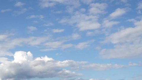 white cumulus clouds moving in the sky - time lapse