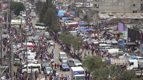 ADDIS ABABA, ETHIOPIA – MARCH 2019: Crowds of people walk through busy shopping street in famous Mercato marketplace in Addis Ababa, Ethiopia