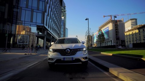 Milan Italy September 12, 2019. Cars moving around the city in the daytime. City life. White cars and taxis. Atmosphere before Milan Fashion Week. City traffic. Autumn trees. Crossover Renault