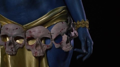 Close up of the skulls and golden clothes on the goddess Kali