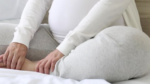 Pregnant woman with cramp in leg, Pain of pregnancy concept