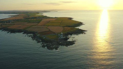 Aerial view, sunrise, high pan right, Hook Lighthouse is situated on Hook Head at the tip of the Hook Peninsula in Co Wexford,Ireland, oldest lighthouse in the world, was built in the 12th century.