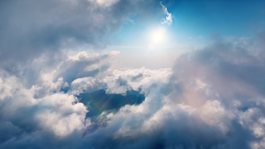 Flying through heavenly beautiful sunny cloudscape. Amazing timelapse of white fluffy clouds moving softly on the sky and the sun shining above the clouds with beautiful rays and lens flare. | Shutterstock HD Video #1036992302