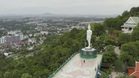 footage video 4k. Sriracha Thailand. Aerial view of Buddha statue in Wat khao phra kru temple located in Sriracha city Chonburi, Thailand