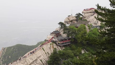 Tourists climbing magnificent Mount Hua or Huashan, a mountain near city of Huayin in Shaanxi, about 120 km east of Xi'an. One of 5 Great Mountains of China with long history of religious significance