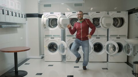 Man Dancing Swing And Have Fun In the Laundry  Room. Happy Man Enjoying Dance, Having Fun Together, Party. Floss Dance Viral, Flossing, swing.