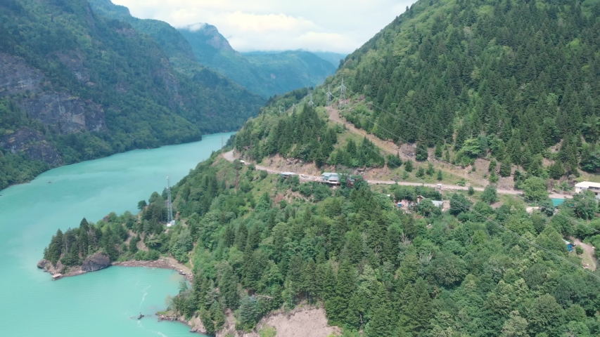 Aerial view from drone of a river amongst mountains and the beautiful nature in Georgia