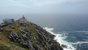 Aerial video of Cape Finisterre in Spain with its lighthouse, the last stop of the pilgrimage to the coast that marks the end of the old world, before the discovery of the Americas