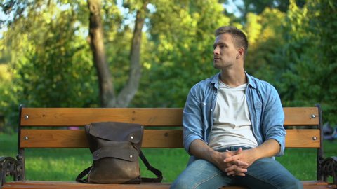 Man relaxing on bench, suddenly feeling strong stomach ache, gastritis problem