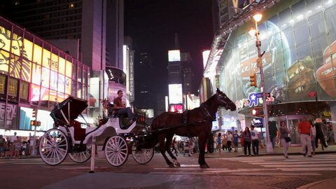 New York , New York / United States - 02 02 2016: New York, NY - CIRCA 2016 - A man in a horse and carriage eagerly awaits his next customer to explore Times Square in Manhattan.