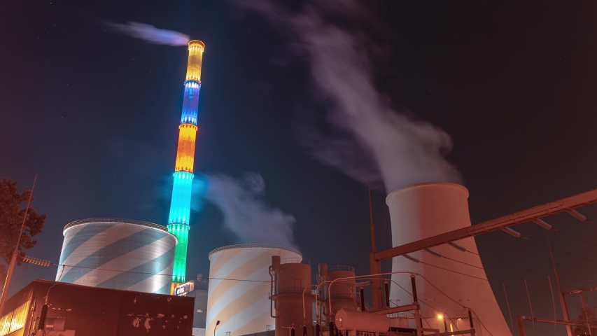Chemnitz, Germany - August 30, 2019: Timelapse from eins energie chemnitz, power plant in Chemnitz with colorful chimney and moving stars and smoke.. Royalty-Free Stock Footage #1037025065
