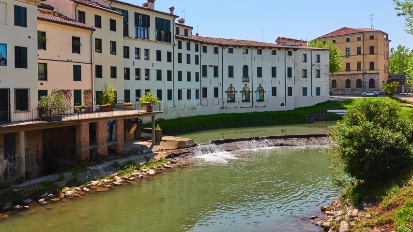 Old buildings on Stradella of Munari Street near Bacchiglione River in historic center of Vicenza, Italy. View from the bridge to Contra Pusterla Street.
