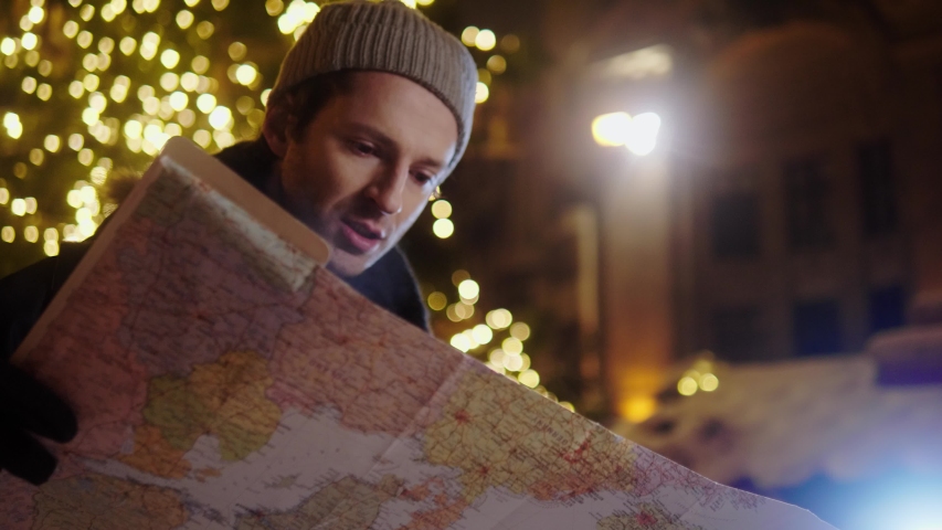 Man with a map on a cold winter evening