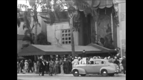 CIRCA 1940s A crowd gathers at Grauman's Chinese Theater, and a ventriloquist and his dummy put their handprints and footprints in concrete.