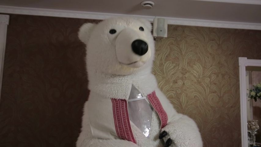 Man wearing a polar bear mask celebrating victory and dancing