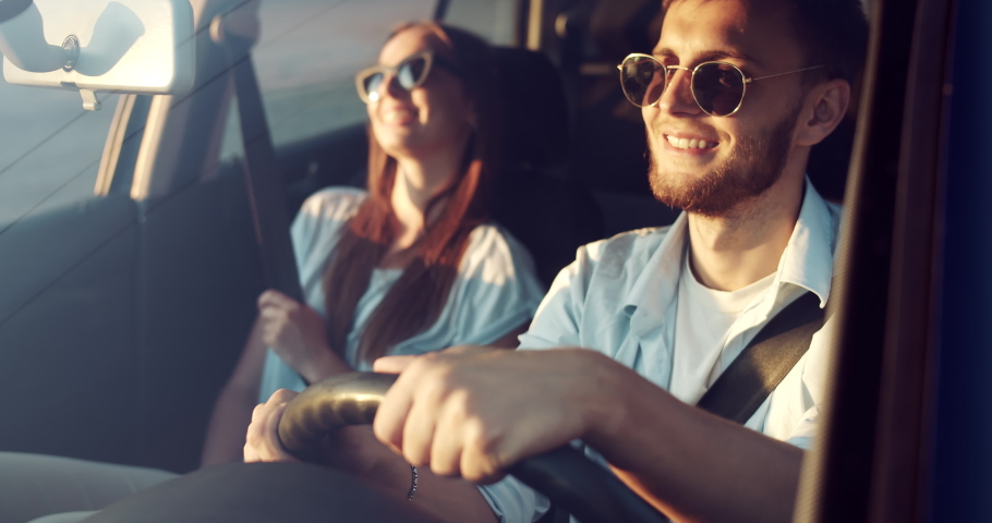Cheerful boyfriend and girlfriend in casual clothing and eyewear enjoying car ride on sunset, vacations Royalty-Free Stock Footage #1037050718