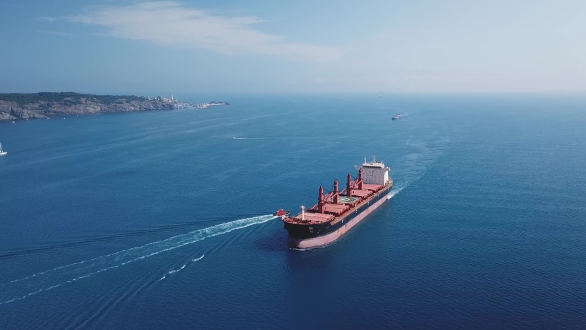 Aerial a cargo ship sailing northbound on Straits Bosporus. A bulk carrier or bulker is a merchant ship specially designed to transport unpackaged bulk cargo, such as grains, ore, coal or timber
 Royalty-Free Stock Footage #1037056172