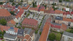 Aerial view of the city Calau in east germany on a cloudy day in summer. Tilt down from behind the market place.