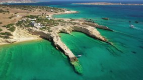 Aerial drone video of Laki paradise beach with beautiful emerald and turquoise sea and small volcanic bays, Kato Koufonisi, Small Cyclades, Greece