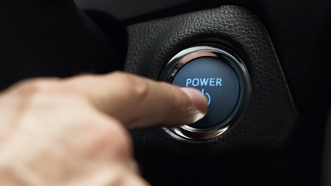 Pushing Blue  Power ignition Button to start keyless ignition hybrid car electro engine