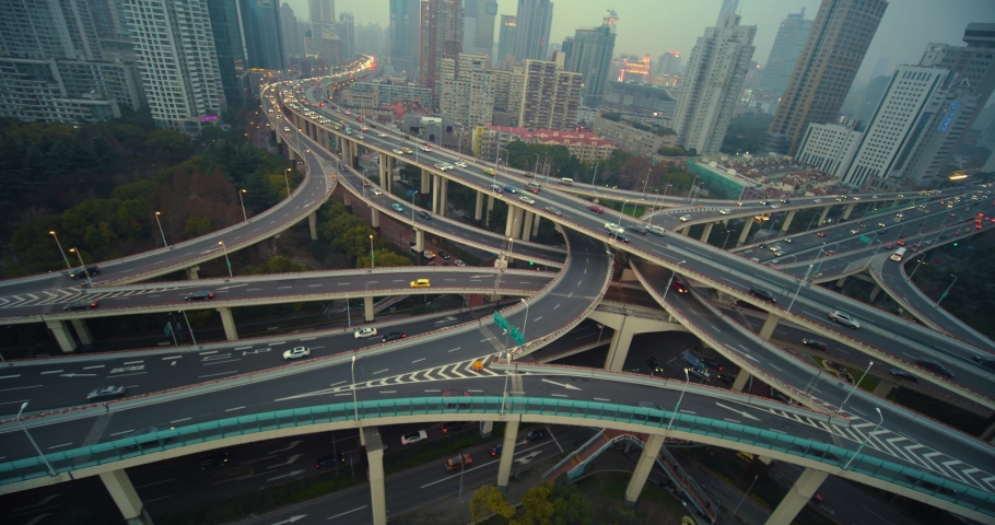 Shanghai Mar 2019: Shanghai city traffic moving in busy intersection junction surrounded by tall modern buildings at night, China | Shutterstock HD Video #1037070566