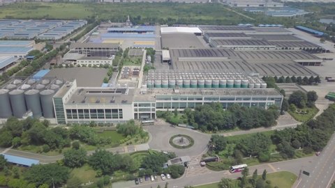China factory industrial zone, warehouses, auto park,garages, reservoirs and workers inside the factories area.Chinese Factory. Top Aerial shot, restricted zone. Flight made under the special license.