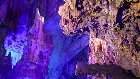 groundwater drops in colourful limestone caves full of stalactite and stalagmite in karst area of limestone in Guilin, China