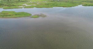 This is a aerial video over East End Lagoon Preserve.