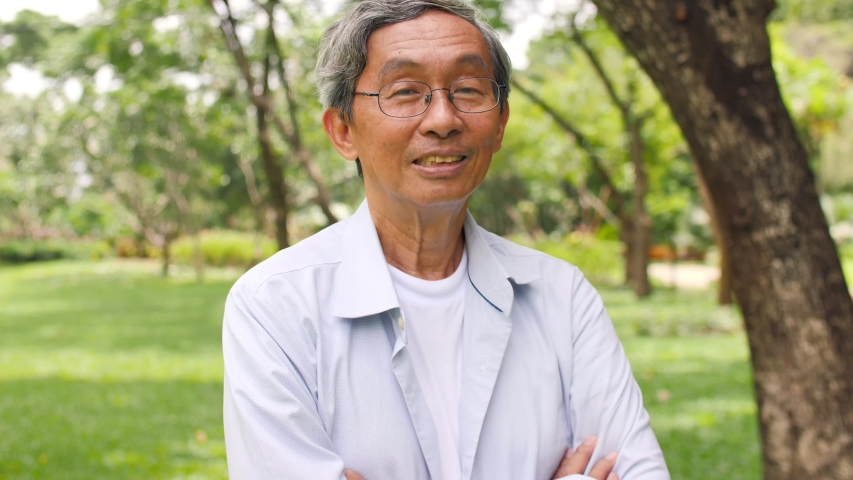 Close up portrait of a smiling senior man in the park