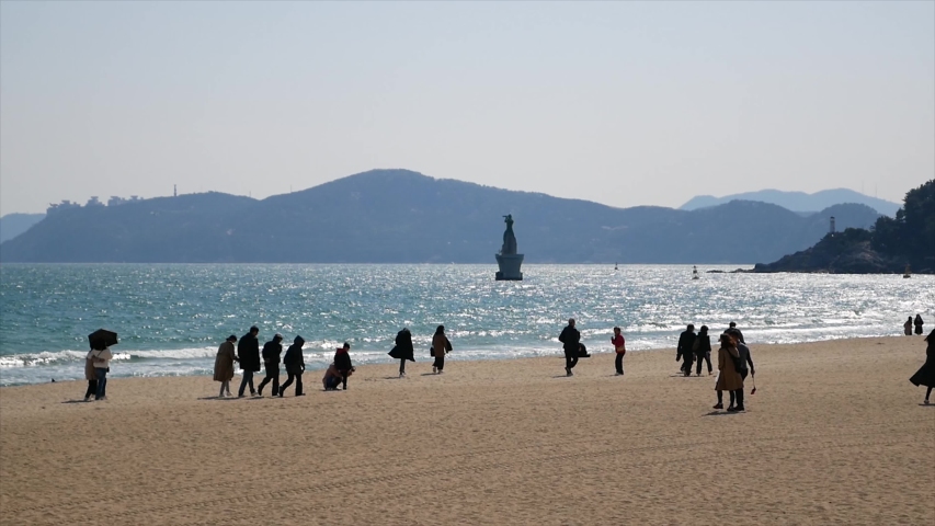 Haeundae beach in Busan city during spring season, South Korea, Asia - Medium Close up of people on the beach - Famous tourist destination.