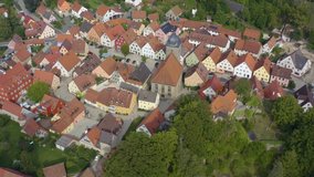 Aerial view of the village Betzenstein in Germany  on a sunny day in summer. Wide view with round Pan to the right at the upper end of the village.