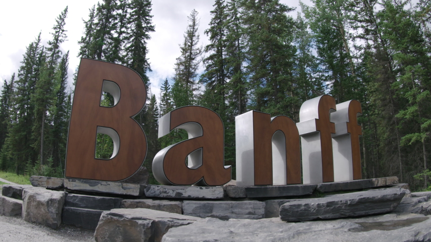 Slider/dolly shot of town of Banff welcome sign.  Banff, Alberta 