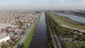 Aerial video from a drone along a polluted river that runs through a large city. Riachuelo, Buenos Aires, Argentina.