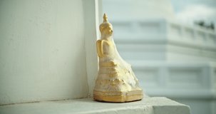 The Golden Buddha is covered with plastic, located in the temple. Camera Panning Shot