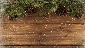 Christmas tree branches on natural wooden table in background and falling snow. - Powered by Shutterstock - Get 15% off with code: PIKWIZARD15