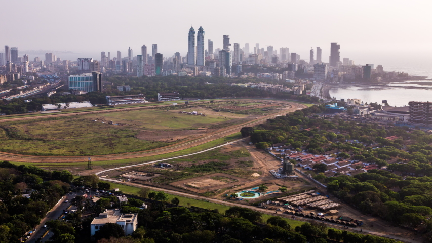 High angle view of Mahalakshmi Race Course Track in front of The Imperial towers and Tardeo business and financial district of Mumbai, India tilt