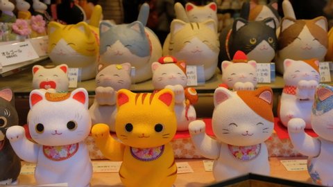Kyoto, Japan - Aug 25 2019: Tourist souvenir shop sells lucky fortune hand waving cat.