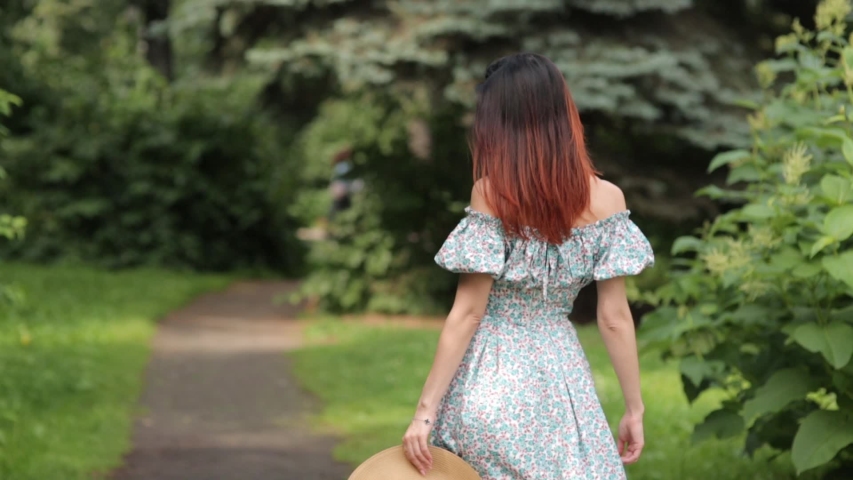 Sunny photo shoot on. Girl in a hat walking in the summer Park. 
