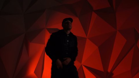 Rapper guy rap in front of the camera on a red background