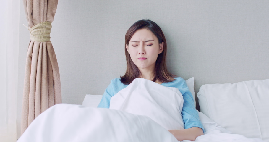 asian woman sick and sneeze with tissue paper in the bedroom Royalty-Free Stock Footage #1037136371