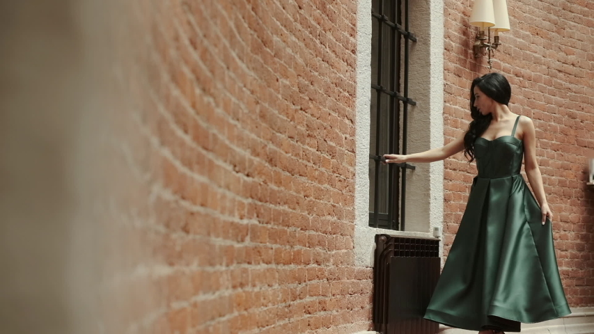 Girl In Seductive Dress. Pretty Girl In Green Dress. Girl Posing Near Stone Wall.
