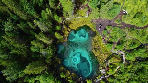 Beautiful Geyser lake with thermal springs that periodically throw blue clay and silt from the ground. Aerial drone view. Aktash, Altai mountains, Russia